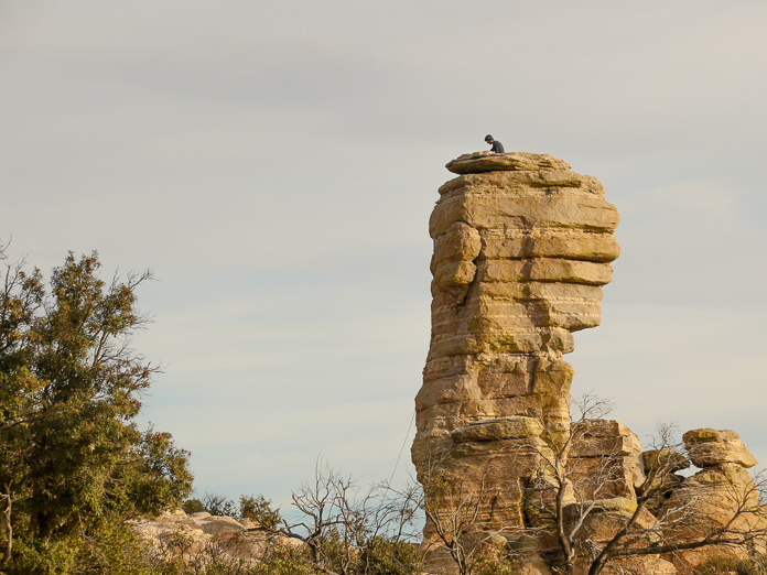 A climber sits atop a large hoodoo at Windy Vista Point, Mt Lemmon Hwy.